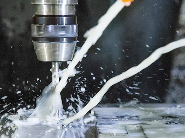 Why is cutting fluid important for effective CNC machining?
